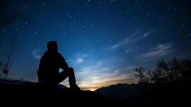 Young adult contemplating celestial life path - Saturn Return & 2026 Astrology: Master Life's Big Shifts